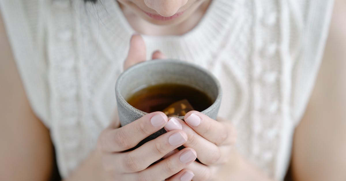 24-hour homemade yogurt: cheesy smell and whey, is it safe? - High angle of crop female smelling aromatic freshly brewed tea in ceramic cup 24-hour homemade yogurt: cheesy smell and whey, is it safe? - High angle of crop female smelling aromatic freshly brewed tea in ceramic cup