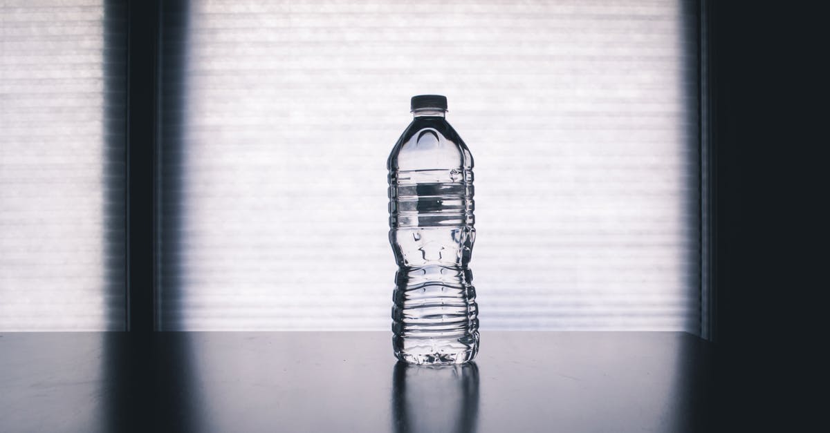 5 Gallon Drinking Water Container - Clear Disposable Bottle on Black Surface 5 Gallon Drinking Water Container - Clear Disposable Bottle on Black Surface