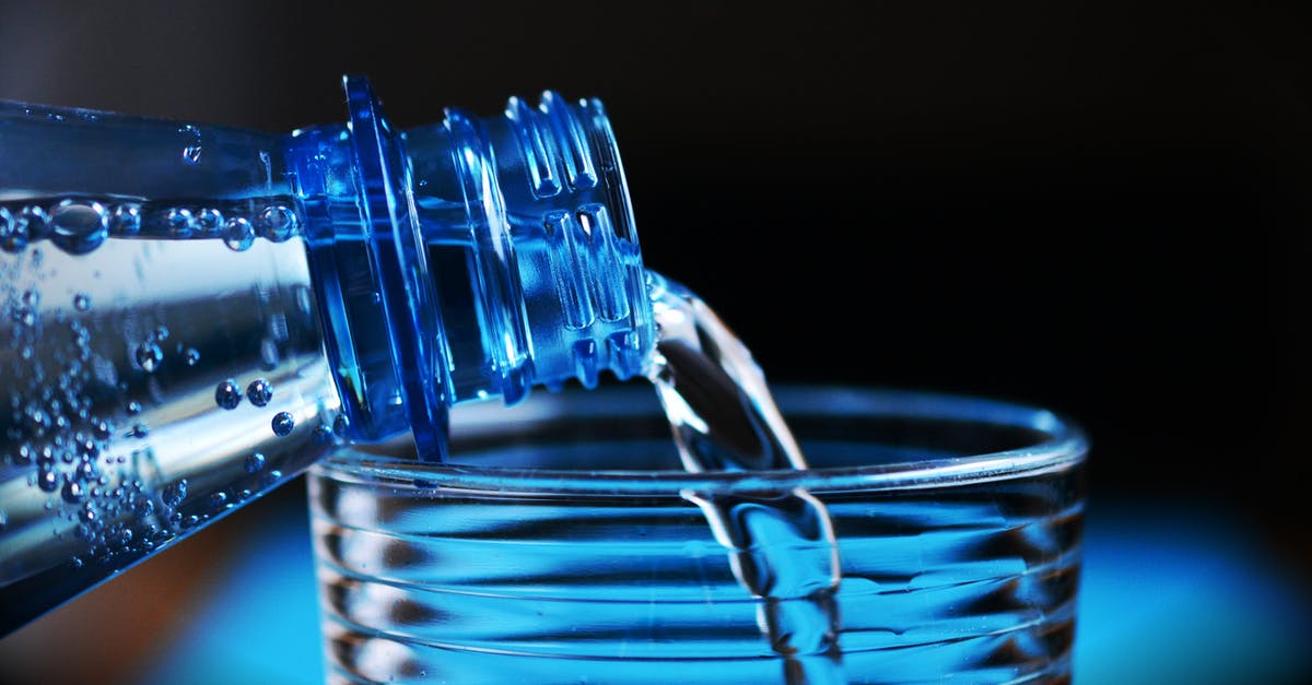 5 Gallon Drinking Water Container - Close-up of Bottle Pouring Water on Glass 5 Gallon Drinking Water Container - Close-up of Bottle Pouring Water on Glass