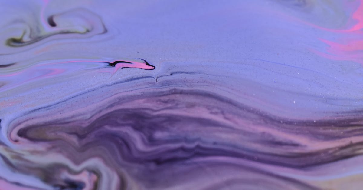 Achieving 'glossy', ultra smooth pudding texture - Full frame abstract background of diffusing purple ink blending and flowing together on uneven surface Achieving 'glossy', ultra smooth pudding texture - Full frame abstract background of diffusing purple ink blending and flowing together on uneven surface