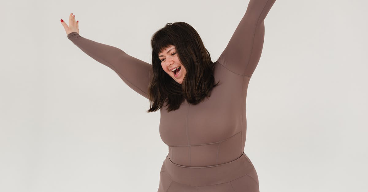 Acmella oleracea (Szechuan buttons) - active chemical for mouth sensation? - Cheerful young plus size female model with dark hair in activewear yelling happily while standing in white studio with raised arms Acmella oleracea (Szechuan buttons) - active chemical for mouth sensation? - Cheerful young plus size female model with dark hair in activewear yelling happily while standing in white studio with raised arms