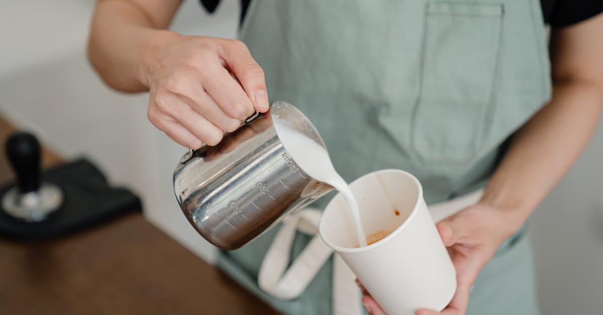 Add fresh yogurt to whipping cream to make creme fraiche? - Anonymous barista pouring milk from jug into paper cup Add fresh yogurt to whipping cream to make creme fraiche? - Anonymous barista pouring milk from jug into paper cup