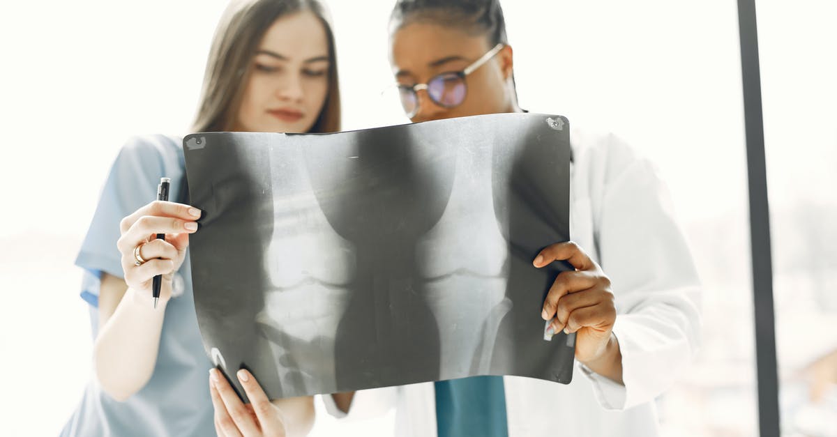 Adding more bones to a finished stock? - Two Doctors Examining an X-Ray Film Adding more bones to a finished stock? - Two Doctors Examining an X-Ray Film