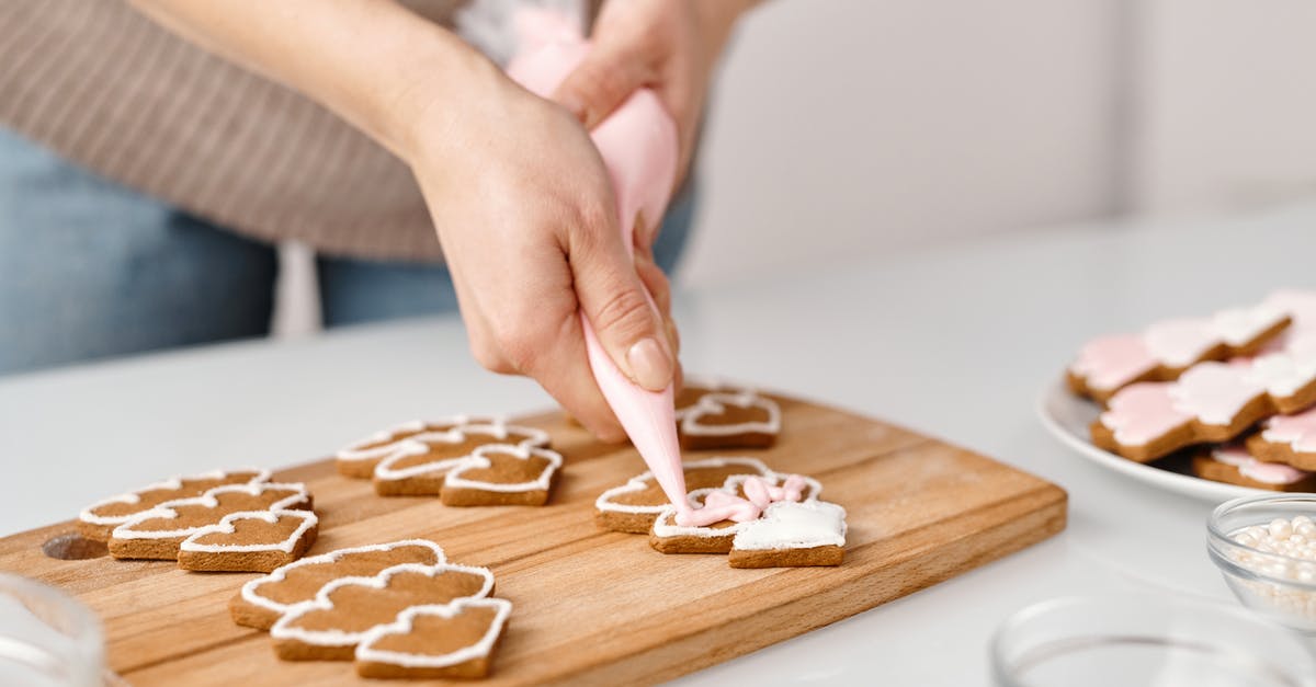 Adding rolled-in seasonings to pita bread - Person Decorating a Christmas Tree Shaped Cookies Adding rolled-in seasonings to pita bread - Person Decorating a Christmas Tree Shaped Cookies
