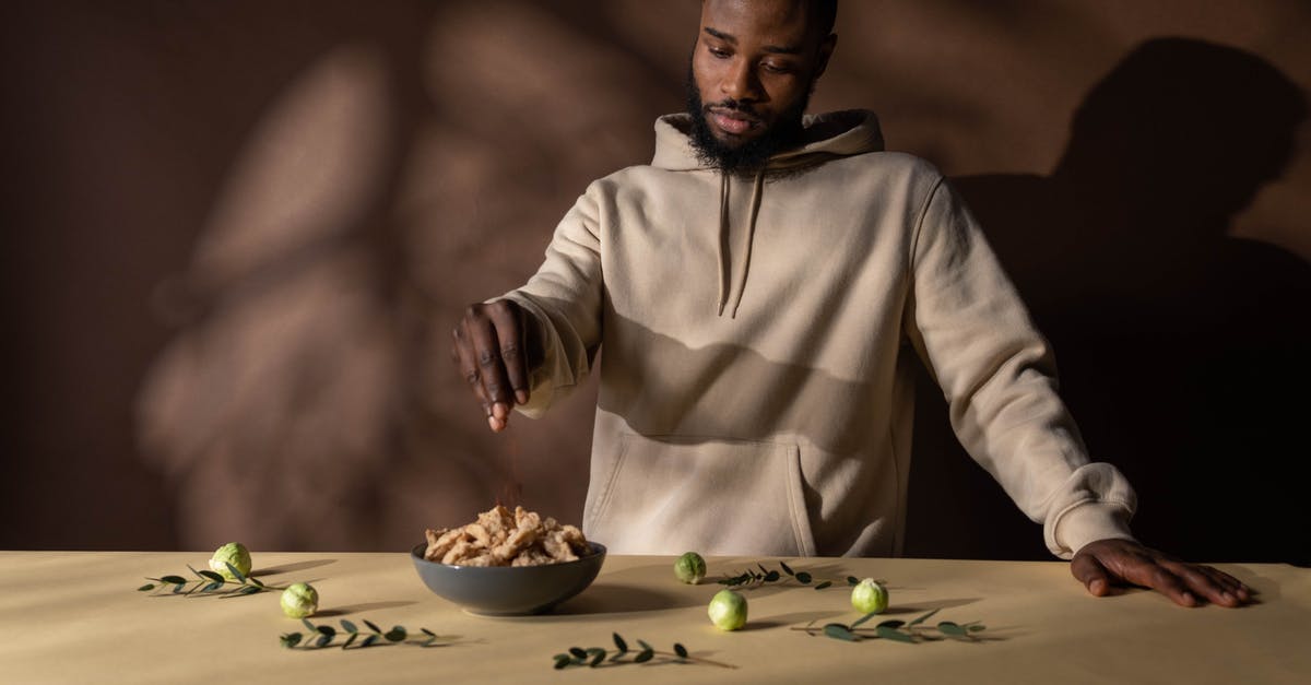 Adding spices before or after frying? - Man in White Hoodie Eating Adding spices before or after frying? - Man in White Hoodie Eating