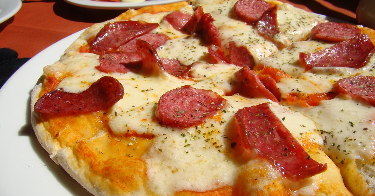 Adding tomatoes to pizza dough - Baked Pepperoni Pizza Adding tomatoes to pizza dough - Baked Pepperoni Pizza