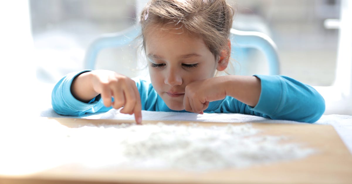 Additional flour threshold: when and how to perform? - Girl in Blue Long Sleeve Shirt Playing on Brown Wooden Table Additional flour threshold: when and how to perform? - Girl in Blue Long Sleeve Shirt Playing on Brown Wooden Table