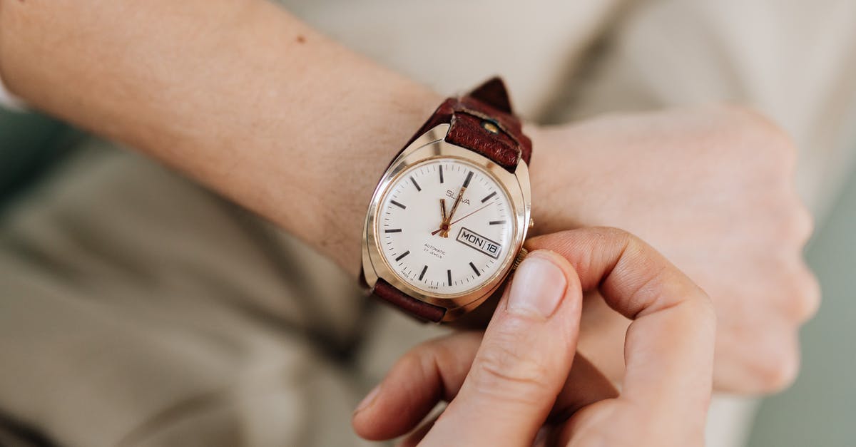 Adjusting Microwave Times - Person Adjusting His Watch Adjusting Microwave Times - Person Adjusting His Watch
