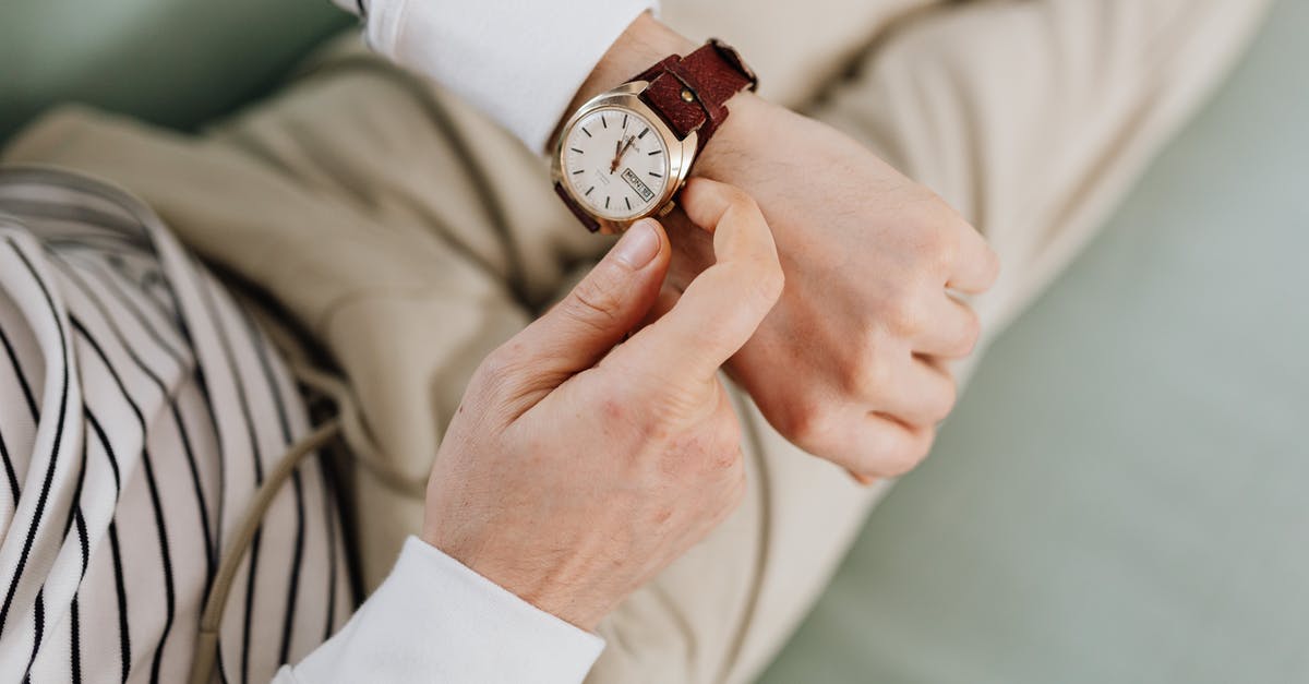 Adjusting Microwave Times - Person Wearing an Analog Wrist Watch Adjusting Microwave Times - Person Wearing an Analog Wrist Watch