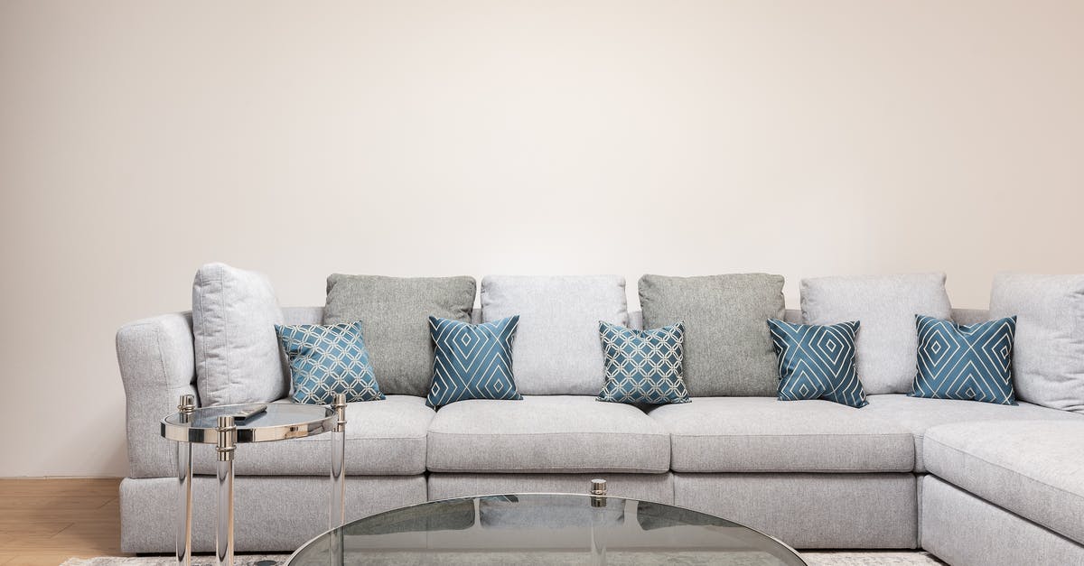 Advantages of metal vs glass stockpot lids - Modern room interior with decorative cushions on couch against round shaped tables on carpet at home