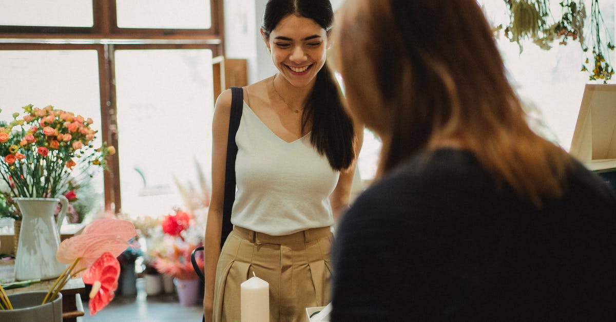 Advice on bulk buying nuts - Happy woman visiting floral shop and buying bouquet Advice on bulk buying nuts - Happy woman visiting floral shop and buying bouquet