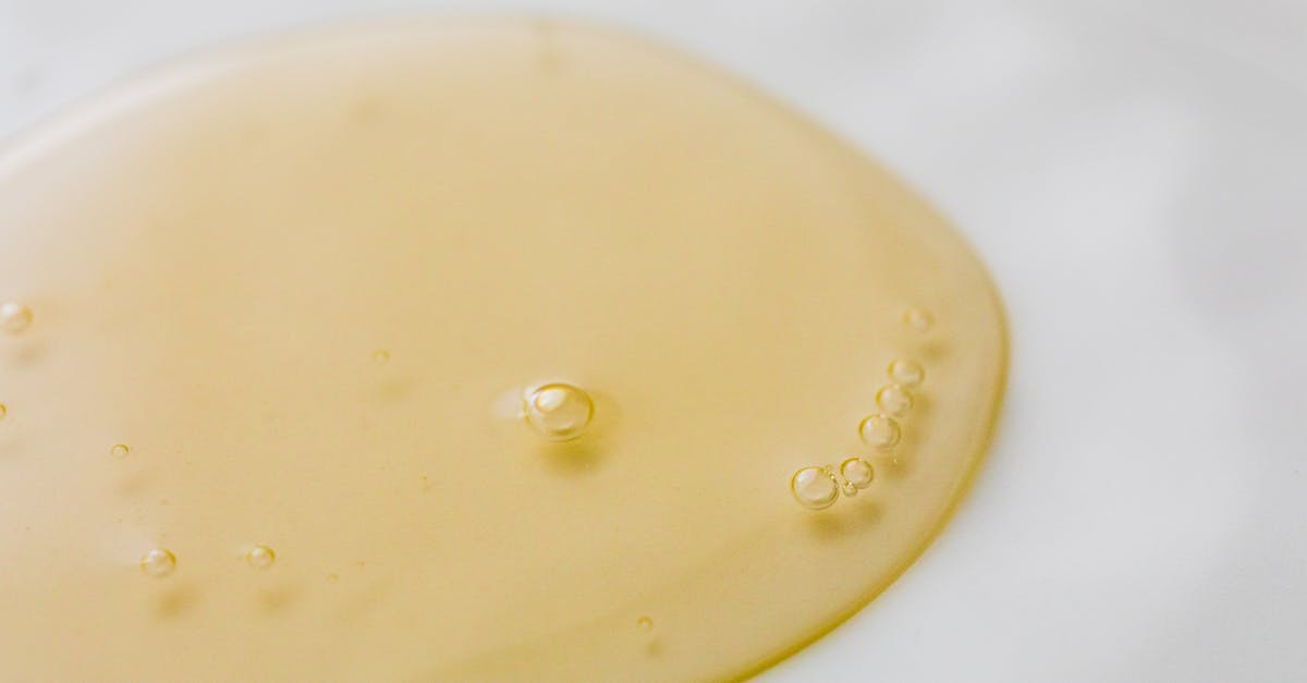 Air bubble on surface of chocolate - Transparent yellowish liquid on white surface Air bubble on surface of chocolate - Transparent yellowish liquid on white surface
