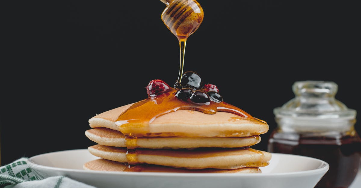 Air fried sweet potatoes have black dots on them - Close-up View of Honey Spoon above Pancakes Air fried sweet potatoes have black dots on them - Close-up View of Honey Spoon above Pancakes