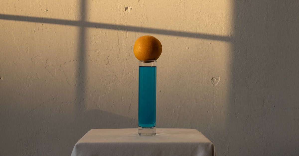 Alcohol level still the same after being soaked with dried fruit - Long glass with blue drink and orange above Alcohol level still the same after being soaked with dried fruit - Long glass with blue drink and orange above