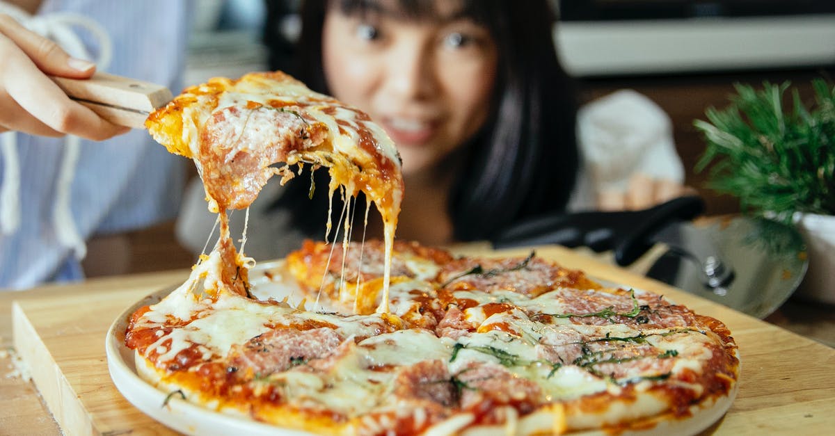 Alfredo sauce - help adding taste - Women taking piece of pizza with tomatoes and cheese Alfredo sauce - help adding taste - Women taking piece of pizza with tomatoes and cheese