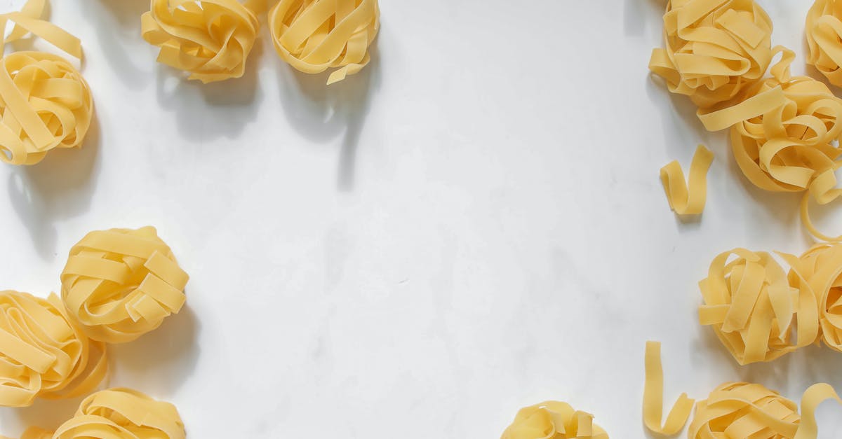 Alkaline ramen noodles shelf life in uncooked state - Uncooked Yellow Noodles on White Surface Alkaline ramen noodles shelf life in uncooked state - Uncooked Yellow Noodles on White Surface