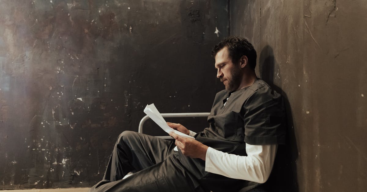 Aluminized Paper Wrapper Sides - Man in Black Jacket and White Pants Sitting on Chair Aluminized Paper Wrapper Sides - Man in Black Jacket and White Pants Sitting on Chair