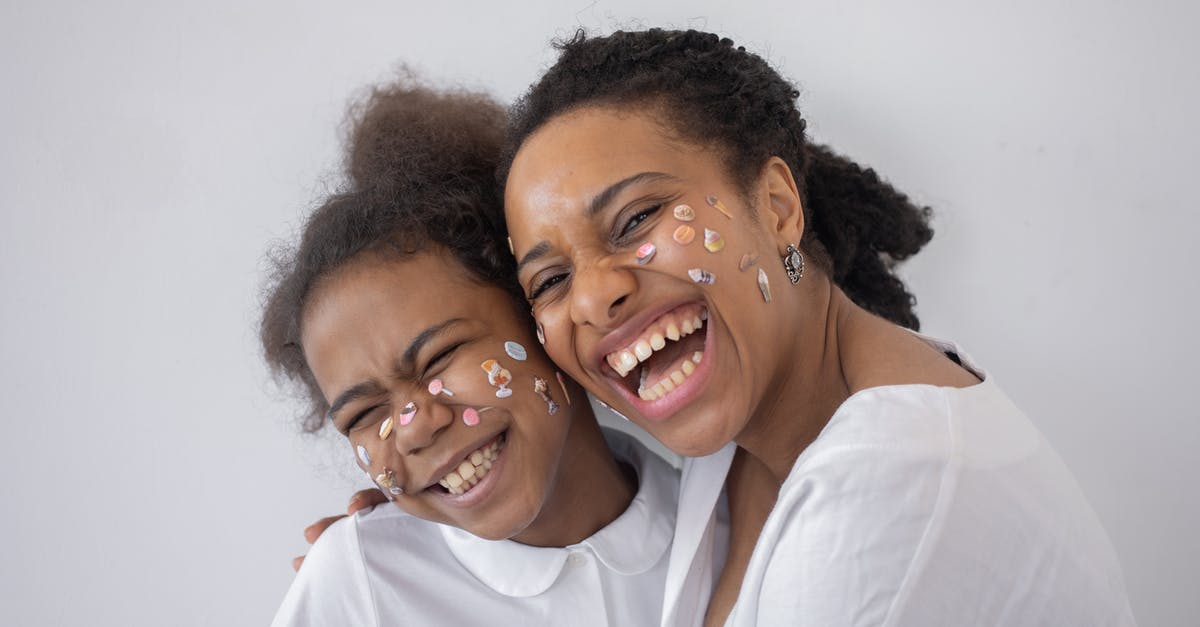 Americans and Shrimp Heads - A Girl and a Woman With Face Stickers Smiling Americans and Shrimp Heads - A Girl and a Woman With Face Stickers Smiling