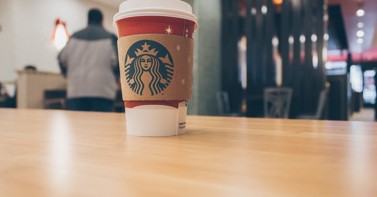 Amount of caffeine per bean of Starbucks bagged coffee (big secret I guess) [closed] - Photo of Paper Cup on Top of the Table