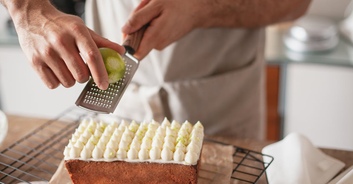 An efficient way to zest key limes? - Close-up of a Person Grating Lemon Zest over a Cake An efficient way to zest key limes? - Close-up of a Person Grating Lemon Zest over a Cake