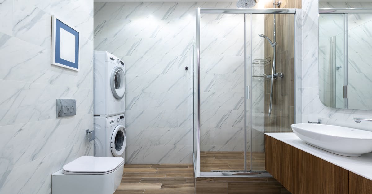 Appliance to wash or scrub fruit and vegetables? Washer or scrubber - Contemporary bathroom toilet near tiled wall against cabinet with sink placed near shower cabin with glass wall and washing machines Appliance to wash or scrub fruit and vegetables? Washer or scrubber - Contemporary bathroom toilet near tiled wall against cabinet with sink placed near shower cabin with glass wall and washing machines