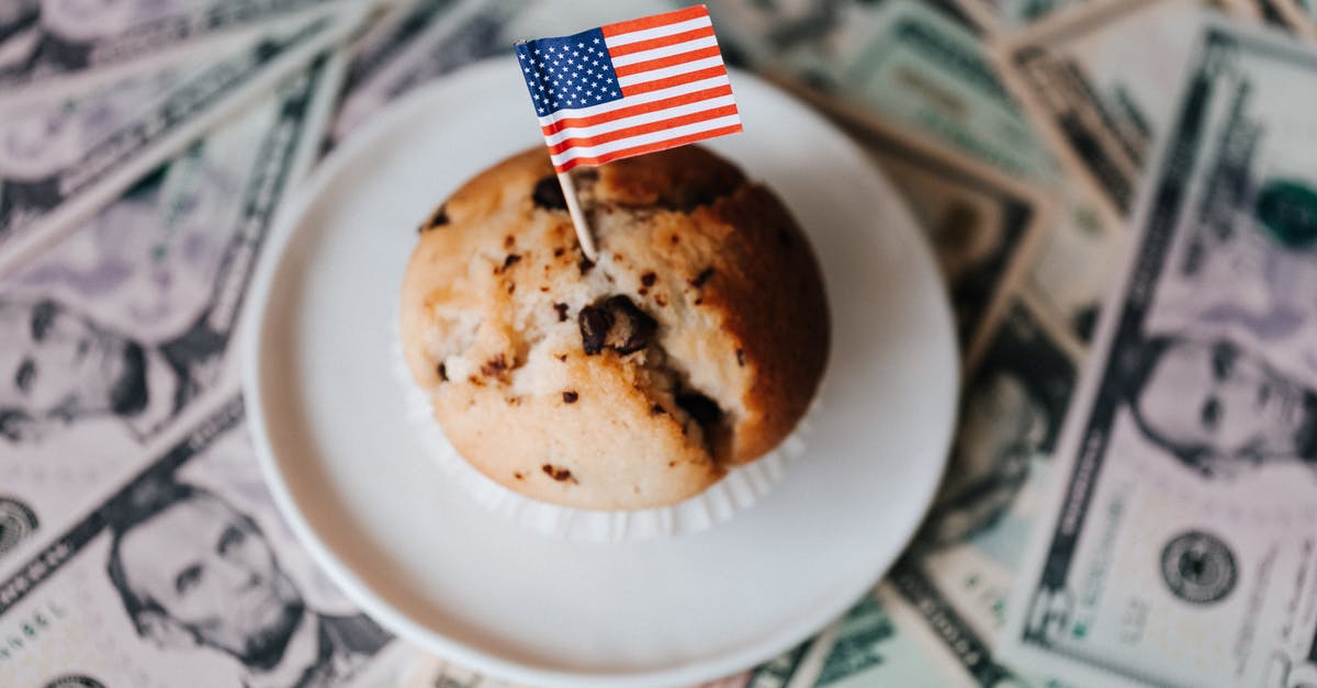 Are American food colourings weaker than in other countries? - Tasty cake with flag on bunch of paper dollars Are American food colourings weaker than in other countries? - Tasty cake with flag on bunch of paper dollars