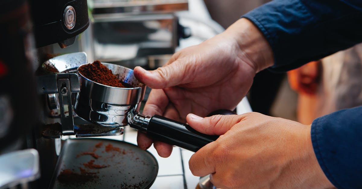 Are Chia Powder and Ground Chia the same product? - Crop barista inserting portafilter into coffee machine at work