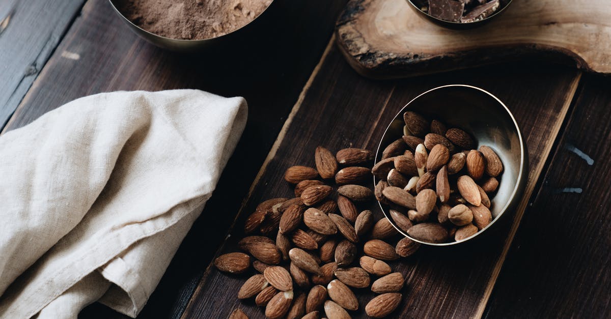 Are commercial chocolate almonds coated with something that prevents melting? - Close-Up Photo Of Almonds Beside Cloth Are commercial chocolate almonds coated with something that prevents melting? - Close-Up Photo Of Almonds Beside Cloth