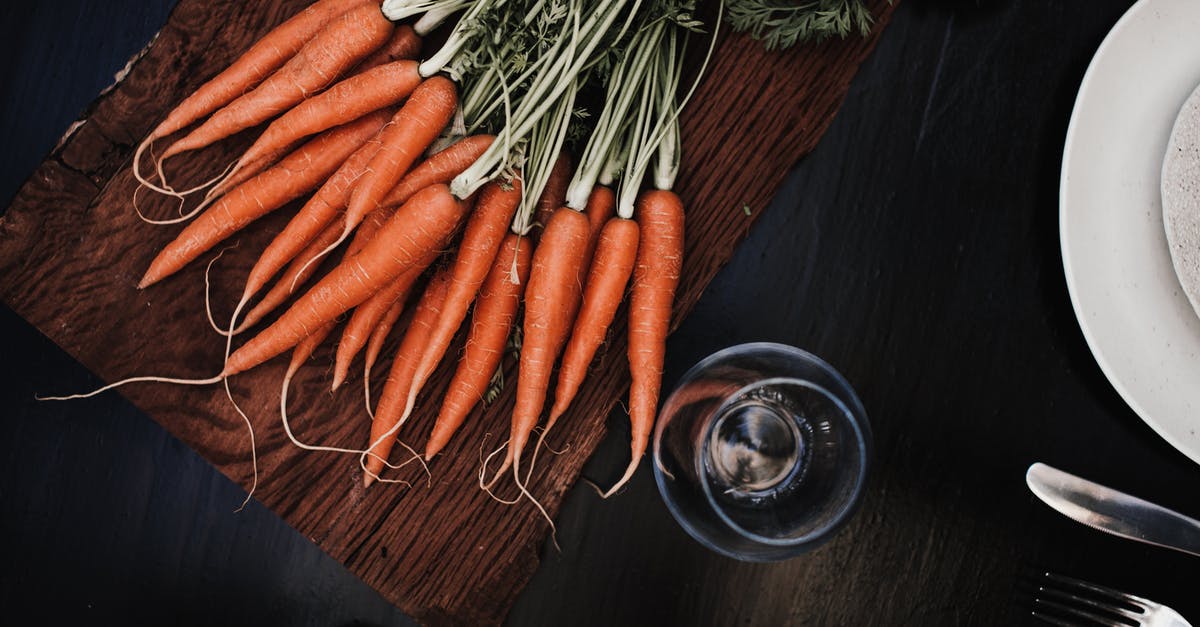 Are Gem Squash Edible After the Green Rind Turns Yellow/Orange? - Top view of ripe carrots placed on timber board near glass and plate with knife and fork Are Gem Squash Edible After the Green Rind Turns Yellow/Orange? - Top view of ripe carrots placed on timber board near glass and plate with knife and fork