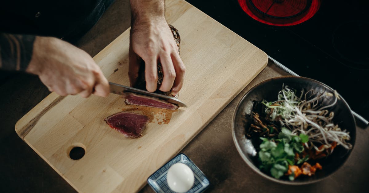 Are Pull N Pak plastic bags appropriate for storing raw or cooked meat in freezer snd vegetables in fridge? - Person Slicing Meat on Wooden Chopping Board
