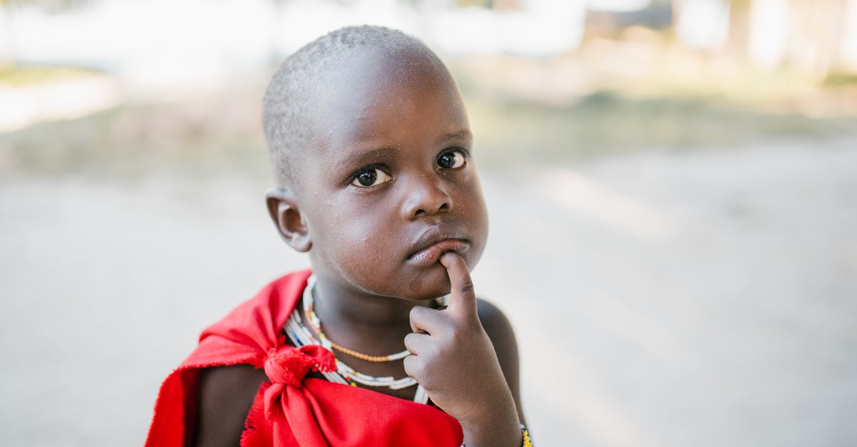 Are red beans supposed to look pruney when soaking? - Curious black child in red cover touching chin and looking at camera with interest while standing on sunny street Are red beans supposed to look pruney when soaking? - Curious black child in red cover touching chin and looking at camera with interest while standing on sunny street