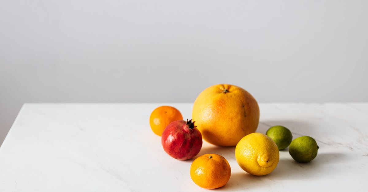 Are ripe meyer lemons supposed to be soft? - Citrus fruits and pomegranate placed on white table Are ripe meyer lemons supposed to be soft? - Citrus fruits and pomegranate placed on white table