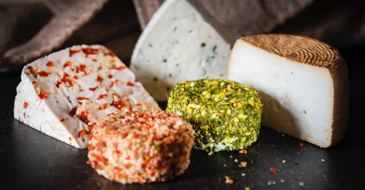 Are the white crystals on my American Cheese safe to eat? - Various types of cheese placed on table Are the white crystals on my American Cheese safe to eat? - Various types of cheese placed on table
