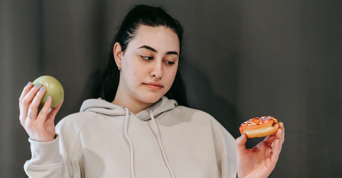 Are there alternative ways to test fruit preserves for doneness? - Thoughtful woman choosing between green apple and sweet donut