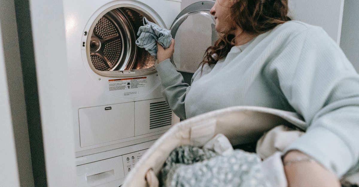 are there any appliances that can automate feeding of sourdough starter? - Woman loading clothes in washing machine