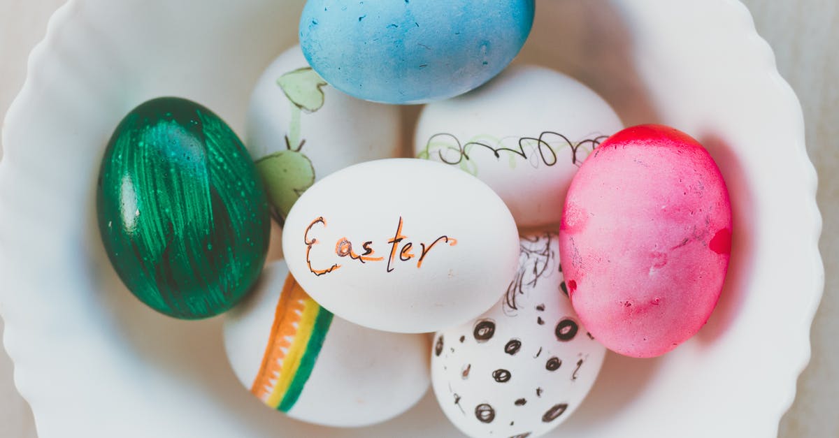 Are there different grades of chicken in the US? - Top view of assorted multicolored chicken eggs with bright handmade ornament in ceramic bowl for festive religious event at home