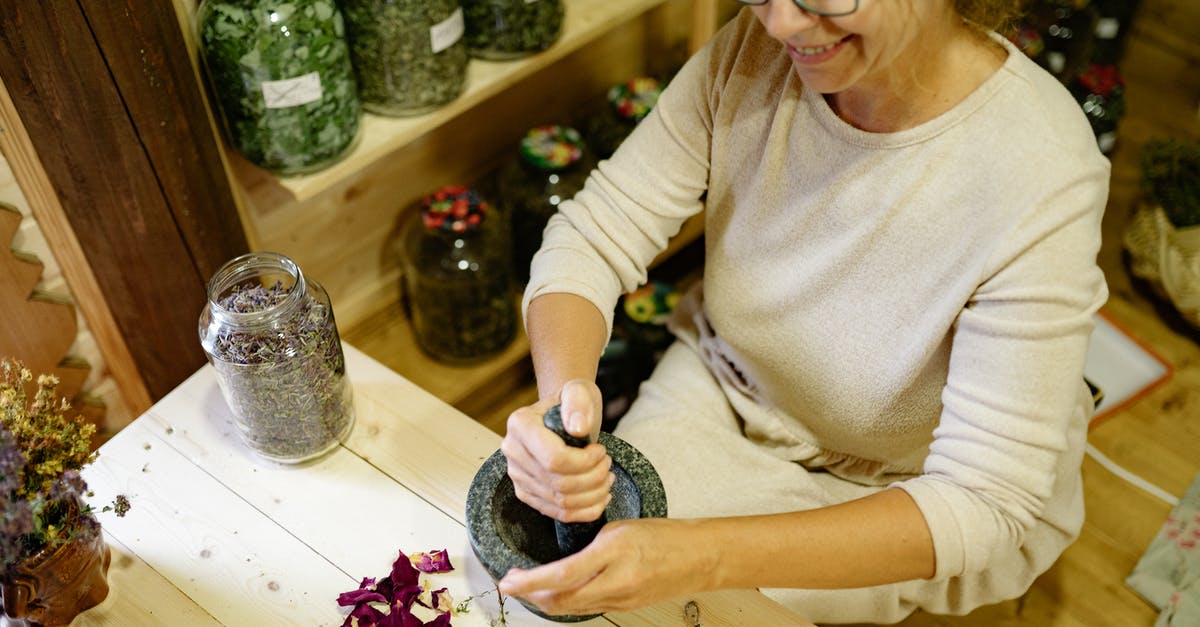 Are there substantial benefits to grinding your own flour? - Woman in Beige Long Sleeve Shirt Holding Black and White Textile Are there substantial benefits to grinding your own flour? - Woman in Beige Long Sleeve Shirt Holding Black and White Textile