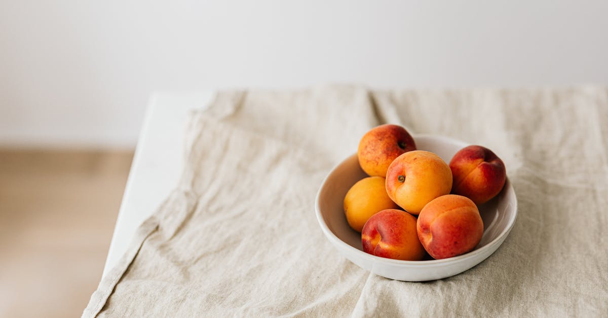 Are there too many flavors competing in this side dish? [closed] - Bunch of ripe apricots in bowl placed on creasy tablecloth on white table