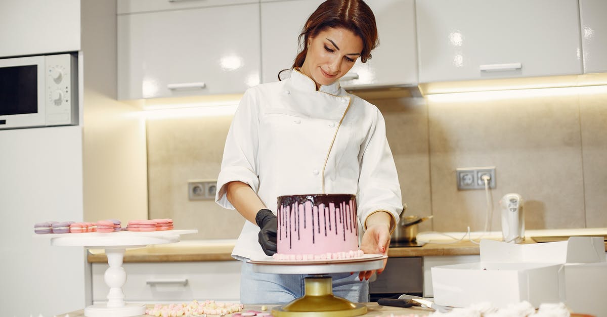 at what temperature should apple-choco pie be prepared? - From below of concentrated female pastry cook in uniform garnishing pink cake with marshmallows among confectionery items in kitchen at what temperature should apple-choco pie be prepared? - From below of concentrated female pastry cook in uniform garnishing pink cake with marshmallows among confectionery items in kitchen