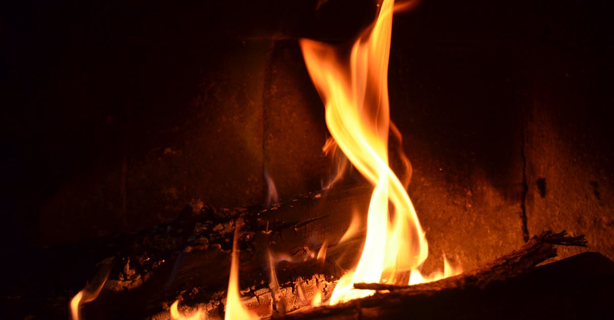 At what temperature should I simmer bolognese to avoid burning? - Burning firewood with bright orange flames in fireplace in dark room at night At what temperature should I simmer bolognese to avoid burning? - Burning firewood with bright orange flames in fireplace in dark room at night