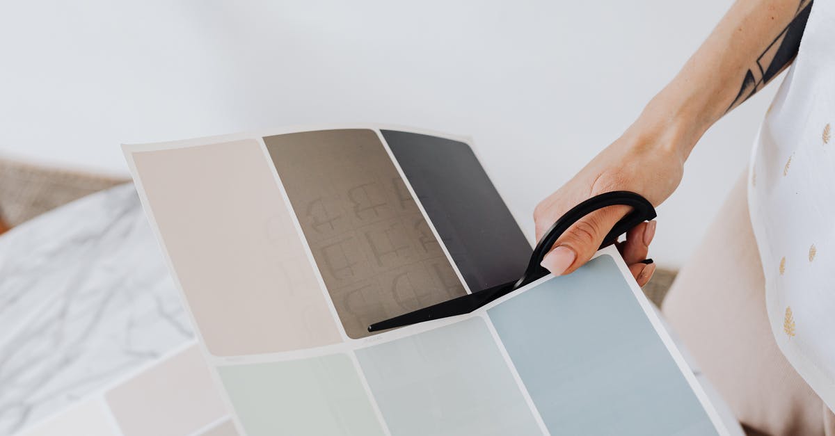 Bacteria in steak from cutting with household scissors by mistake? - Woman Cutting Paper with Paint Samples Bacteria in steak from cutting with household scissors by mistake? - Woman Cutting Paper with Paint Samples