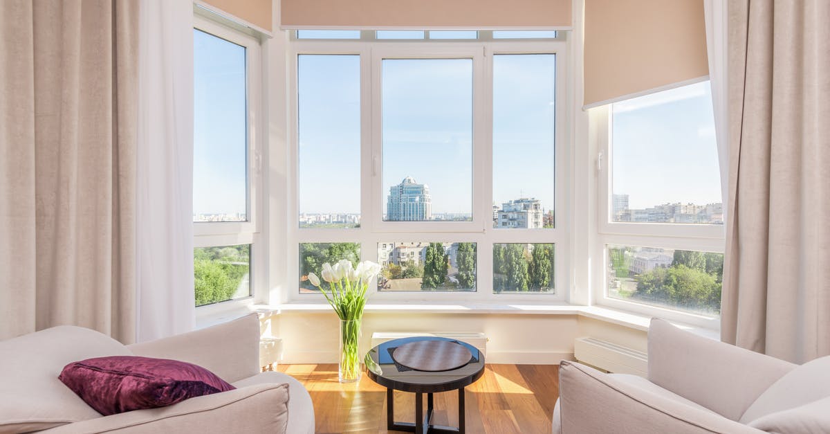 Bagels: Flat, no rise, gummy inside. Over kneading? - Interior of modern penthouse with comfortable white armchairs and round side table placed near windows overlooking city in sunny day Bagels: Flat, no rise, gummy inside. Over kneading? - Interior of modern penthouse with comfortable white armchairs and round side table placed near windows overlooking city in sunny day