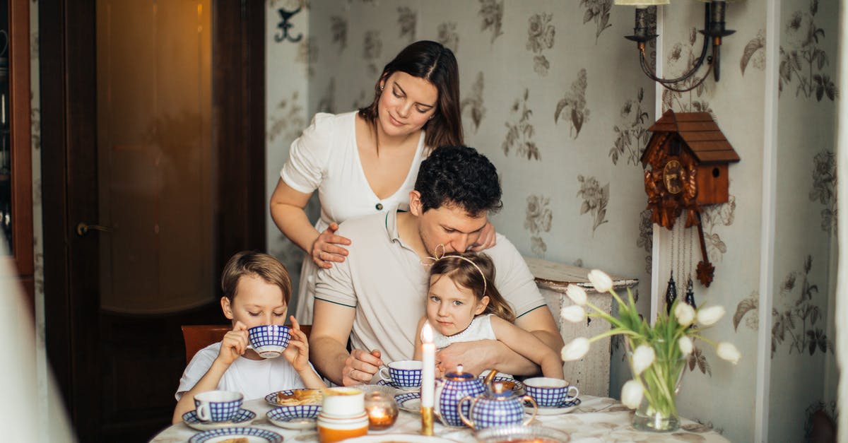 Bailey's curdled in coffee? - Cheerful family drinking tea at home Bailey's curdled in coffee? - Cheerful family drinking tea at home