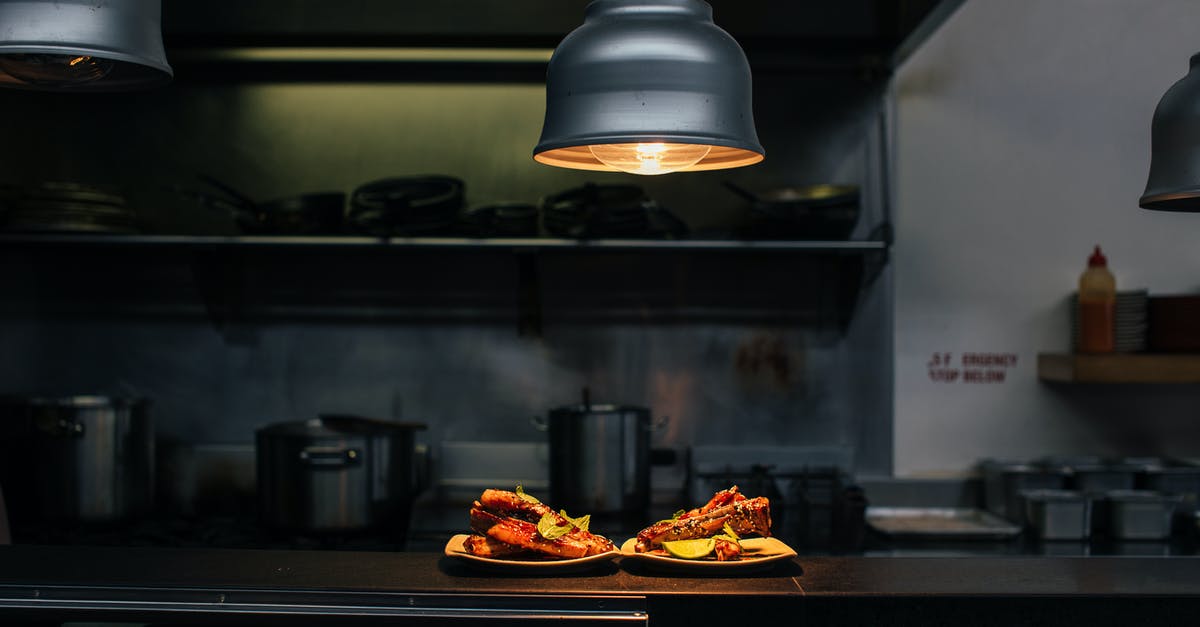 Baking a cake in a larger/smaller pan - Plates with sweet cakes under lamp in kitchen Baking a cake in a larger/smaller pan - Plates with sweet cakes under lamp in kitchen