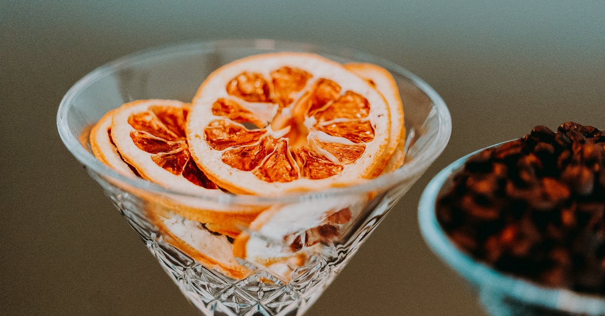 Baking or Cooking - why orange and not other sweet citrus fruit? - Colorful slices of citrus in conical transparent festive glass in daylight on blurred background Baking or Cooking - why orange and not other sweet citrus fruit? - Colorful slices of citrus in conical transparent festive glass in daylight on blurred background