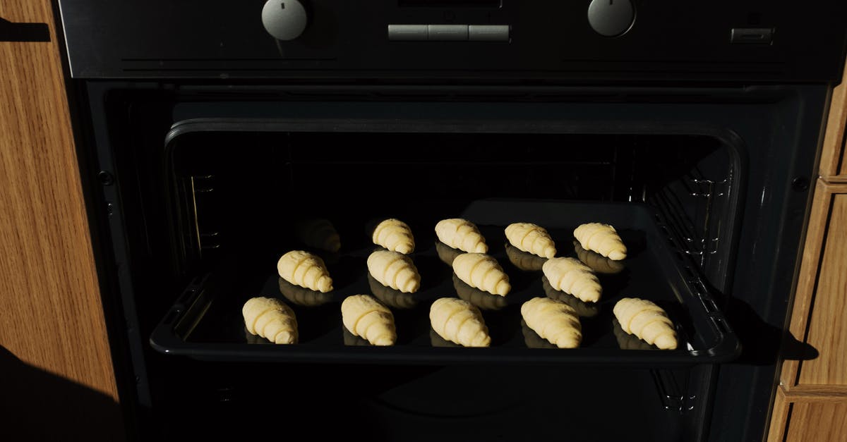 Baking yeast breads in gas oven? - Black Tray with Croissants Inside the Oven Baking yeast breads in gas oven? - Black Tray with Croissants Inside the Oven
