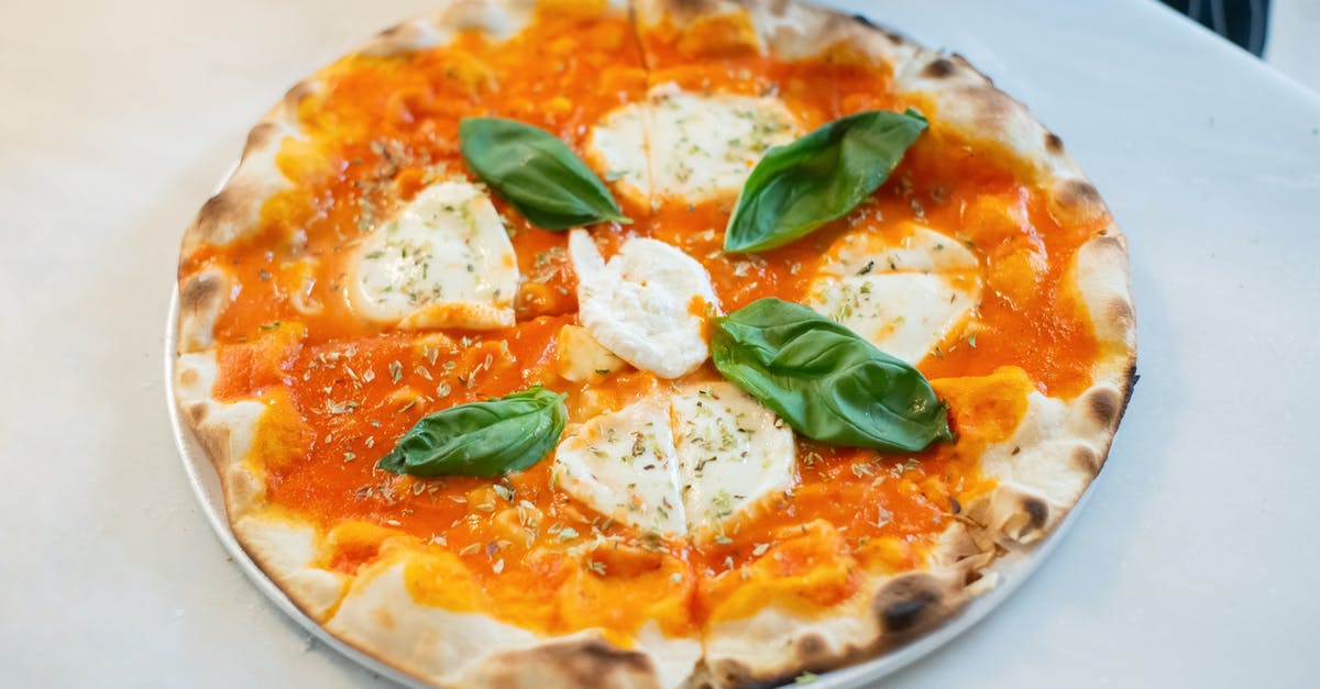 Balancing out a good souffle and burnt cheese on top - A Thin Sliced Saucy Pizza Topped with Cream Cheese and Basil Leaves Balancing out a good souffle and burnt cheese on top - A Thin Sliced Saucy Pizza Topped with Cream Cheese and Basil Leaves