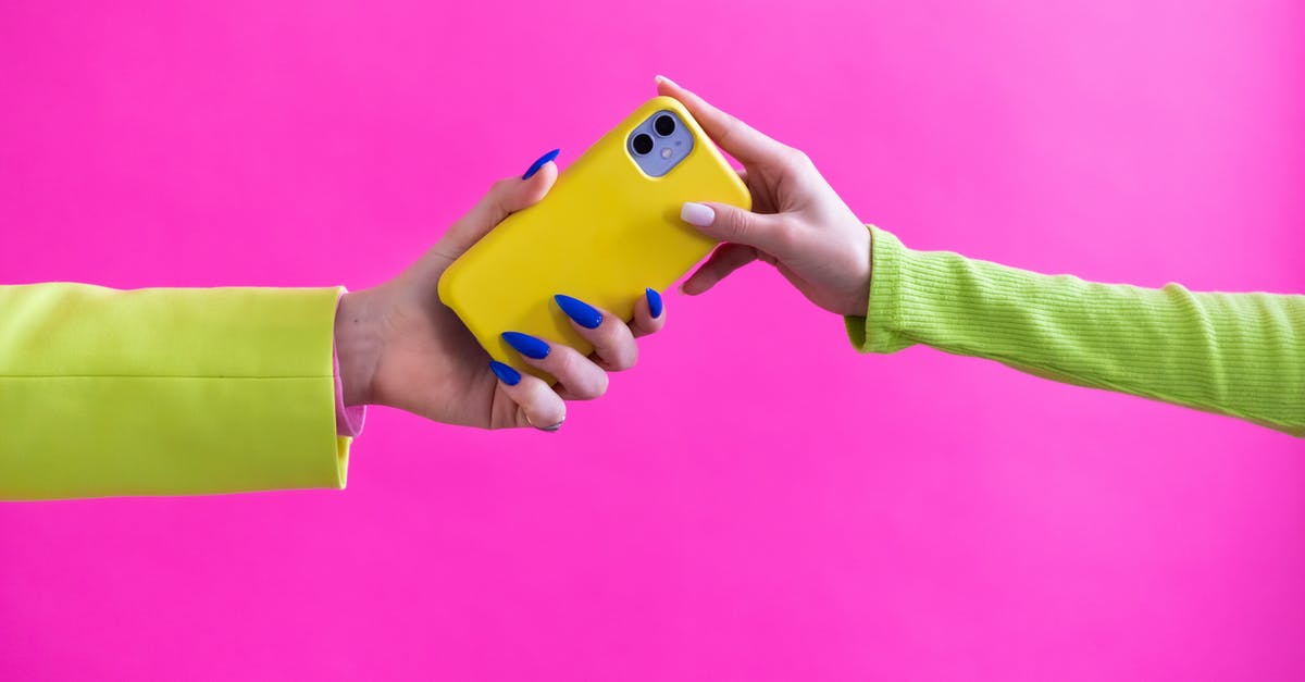 Ball Canning Jars: Use them over and over? - Unrecognizable Woman Handing Over Mobile Phone to Another Woman Ball Canning Jars: Use them over and over? - Unrecognizable Woman Handing Over Mobile Phone to Another Woman