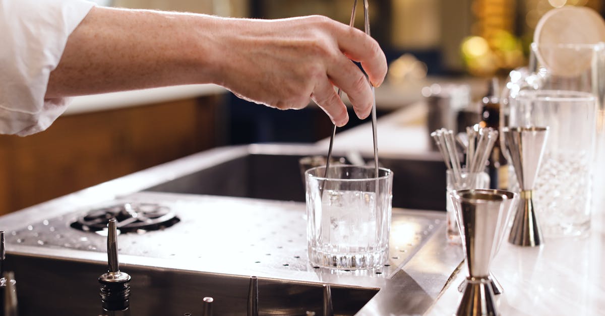 Bar ware - What kind of glass is this? - Person Pouring Water on Drinking Glass Bar ware - What kind of glass is this? - Person Pouring Water on Drinking Glass