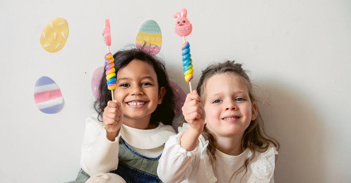 Beating Egg Whites with Granulated Sugar Added for Tapioca Pudding - Cheerful multiracial children with sweet Easter bunny candies looking at camera while sitting on white background with egg decorations during holiday celebration